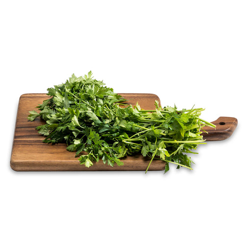 Acacia wood serving board with handle, shown with fresh parsley (not included)