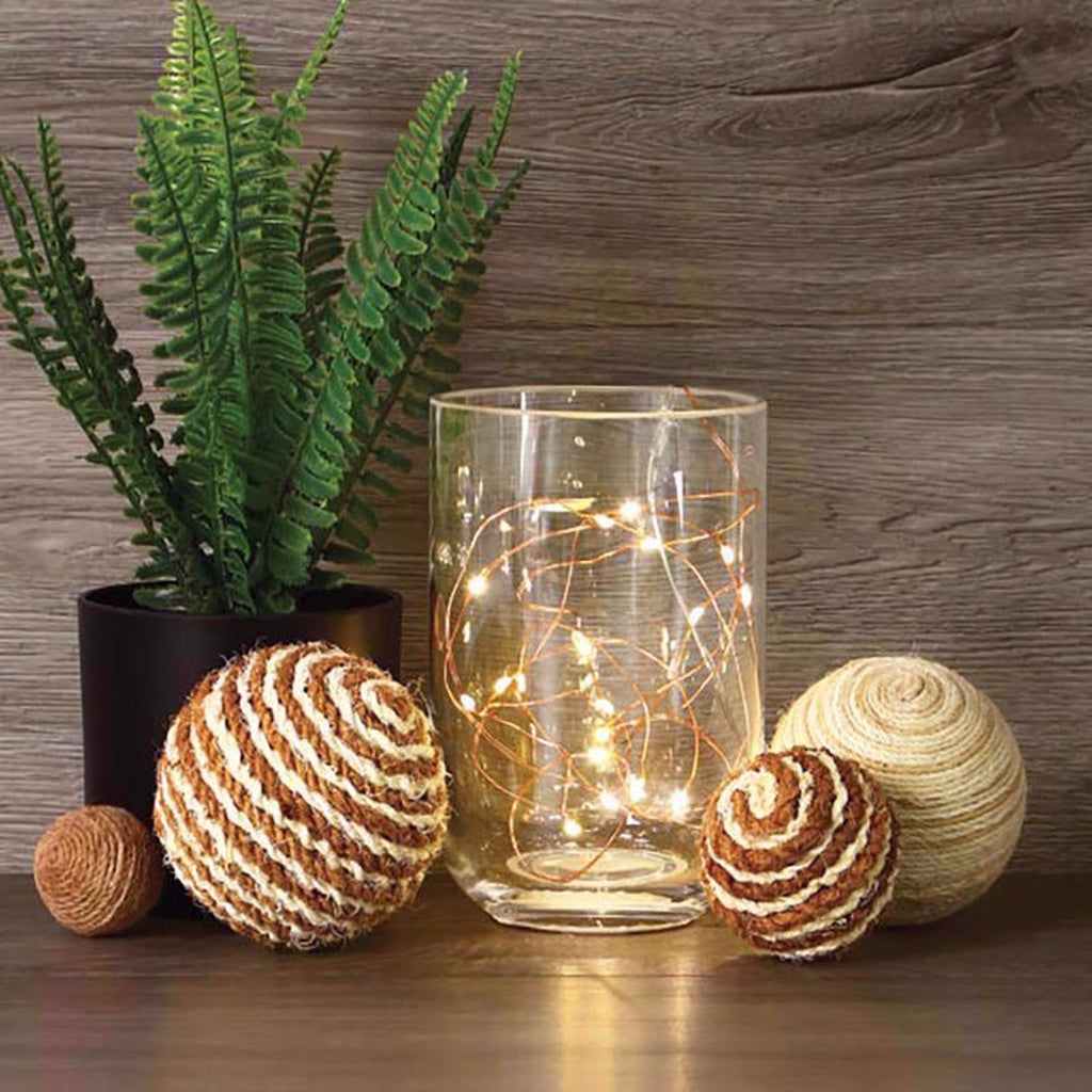 Warm white copper-wire fairy lights glowing inside a glass jar (jar and decor not included)